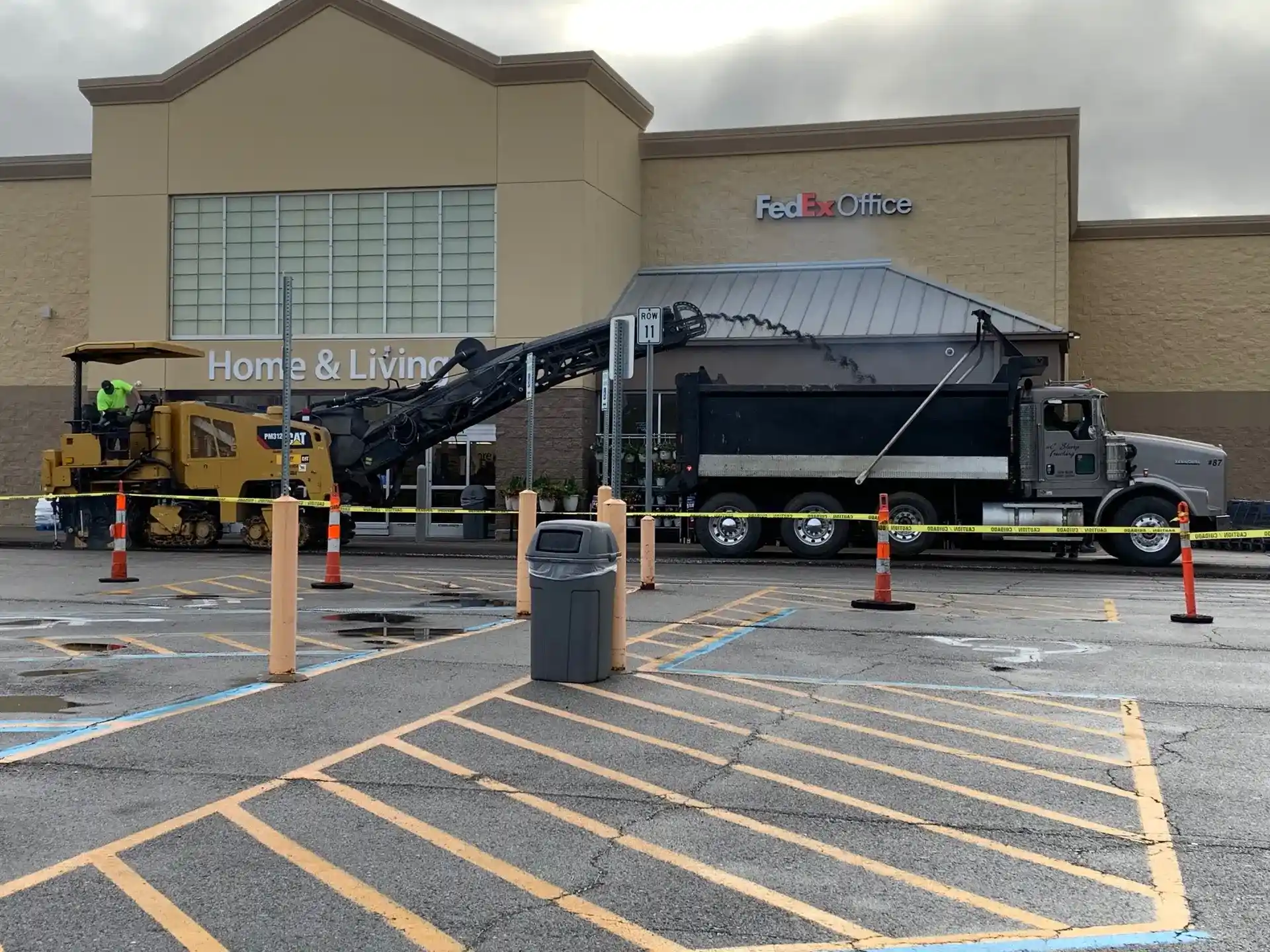 Asphalt milling in Kansas City — Cat cold planer removing the surface course on a retail lot