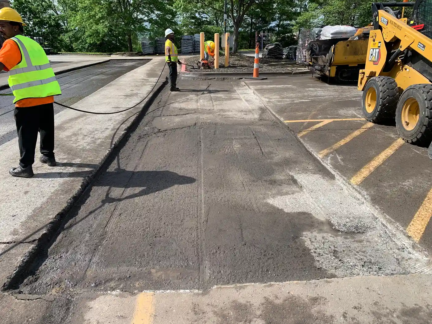 Platinum Paving crew with skid steer and milling equipment on a Kansas City job site