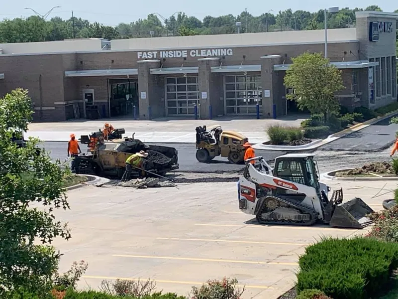 Crack sealing on a Kansas City commercial parking lot — hot rubberized sealant application