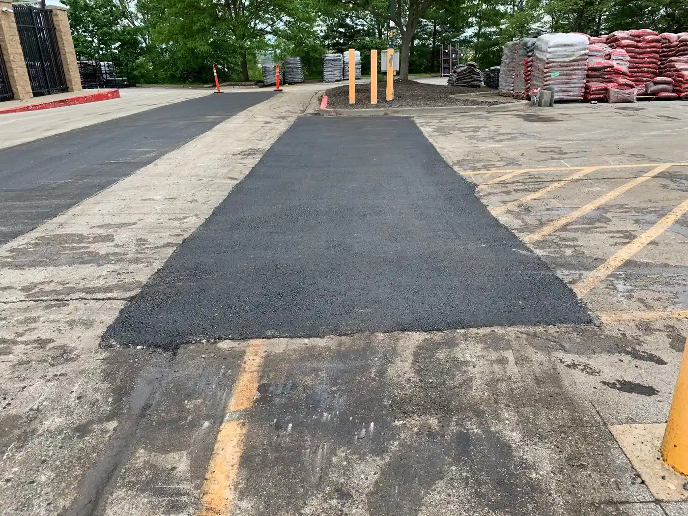 Asphalt repair and patching in Kansas City — clean rectangular saw-cut patch on a commercial lot